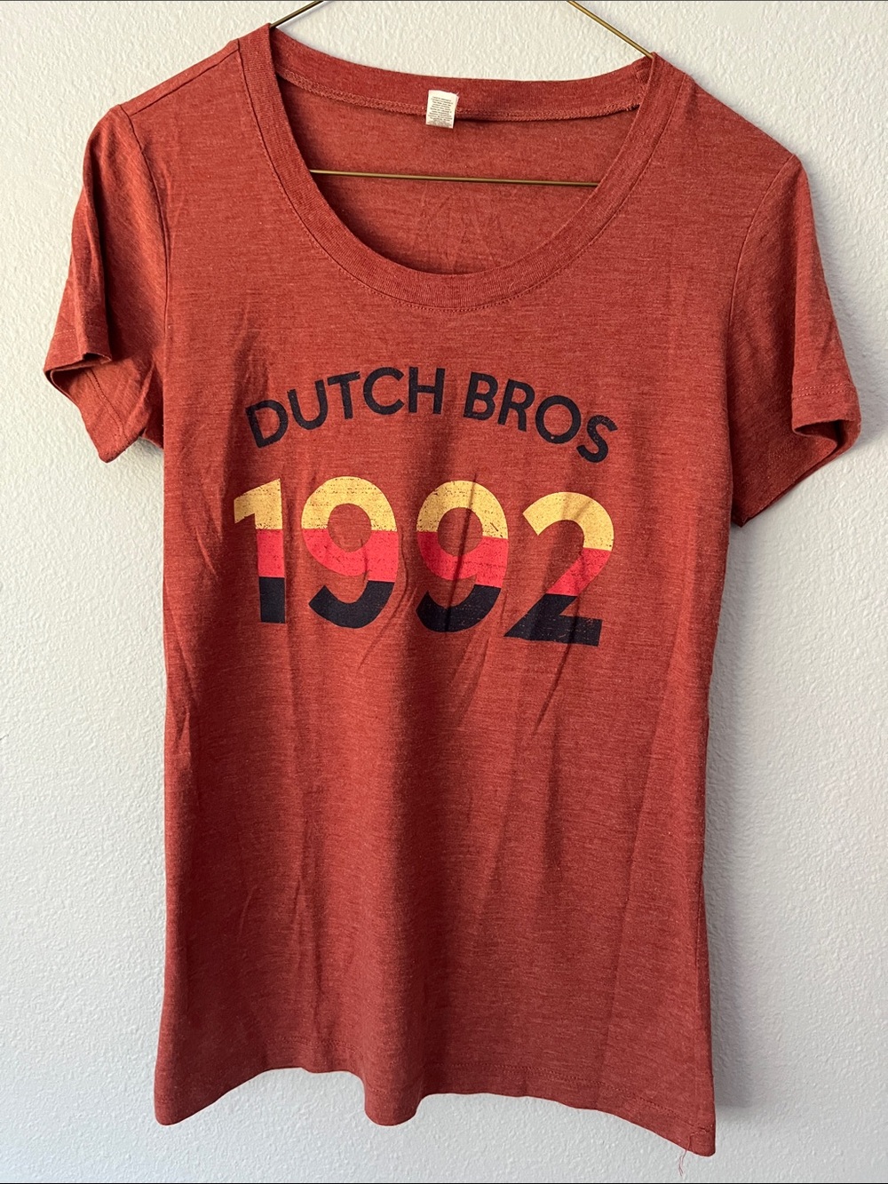Dutch Bros Rust Red Tee with Black, Yellow and Red Print